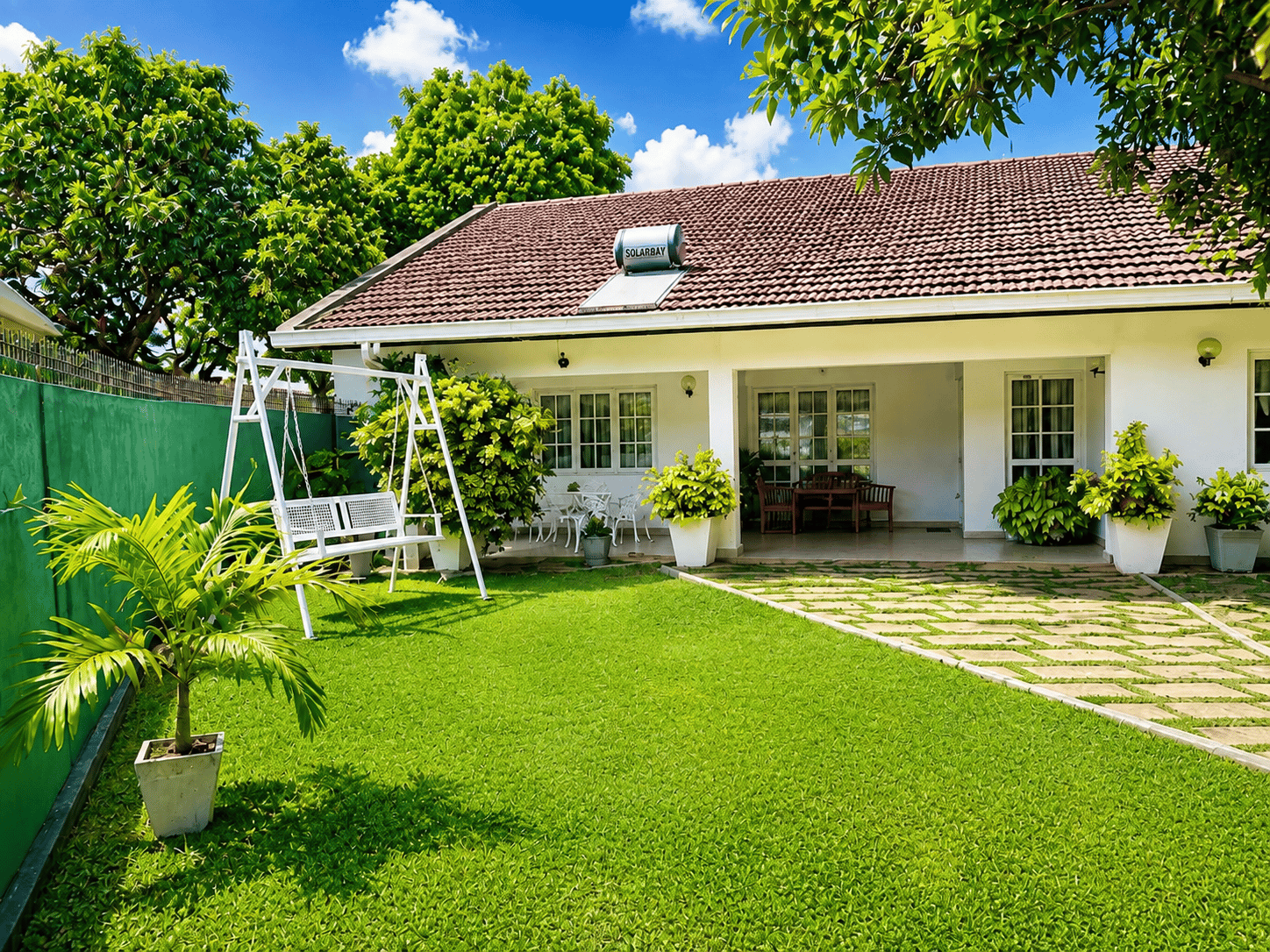 Front lawn with swing and villa entrance