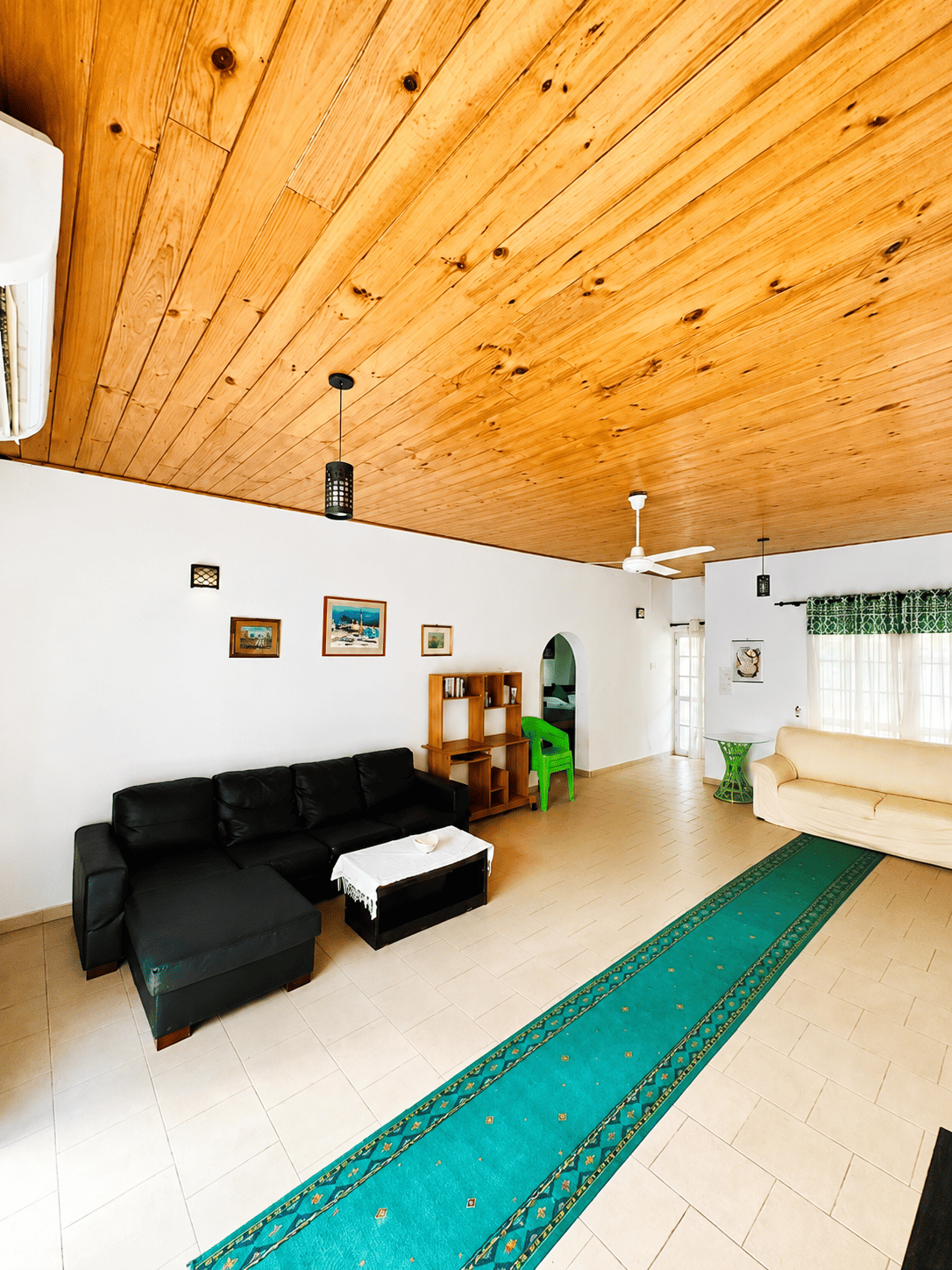 Villa living room with wood ceiling and lounge seating