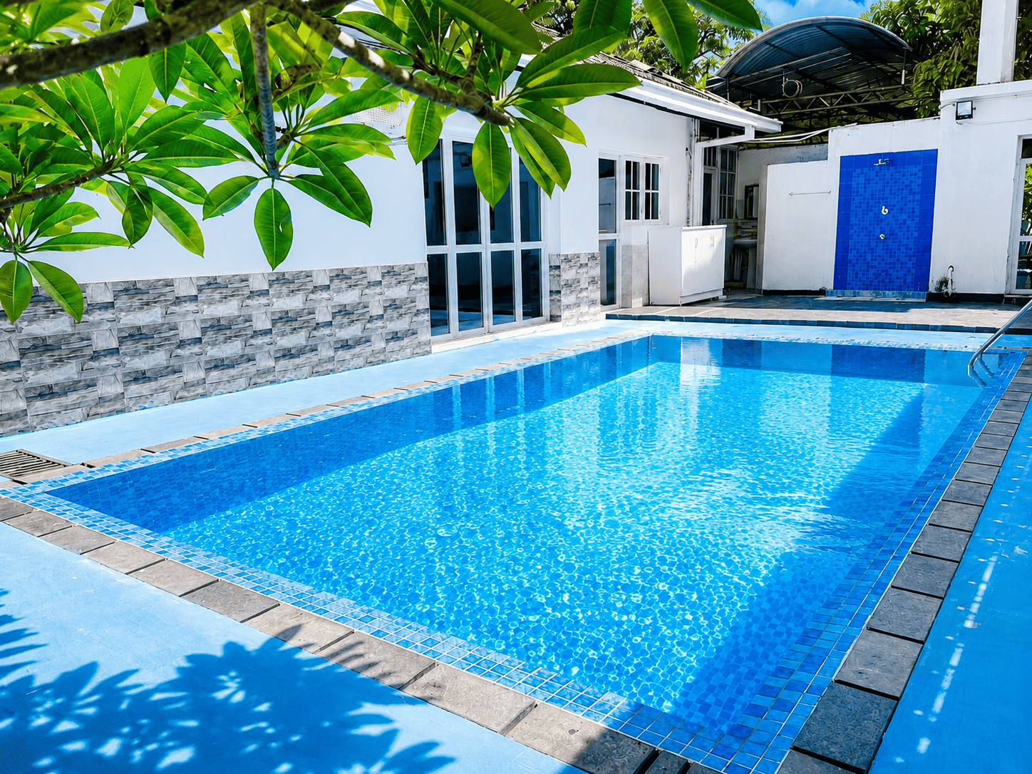 Bright blue private pool beside the villa