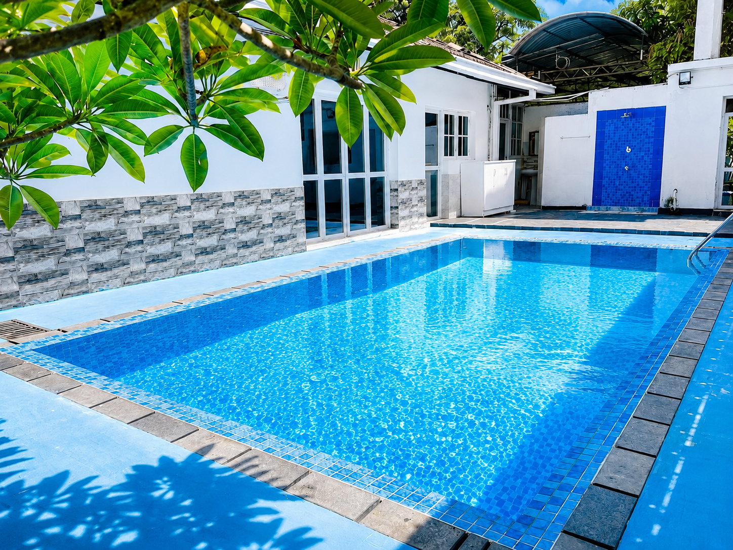 Bright blue private pool beside the villa